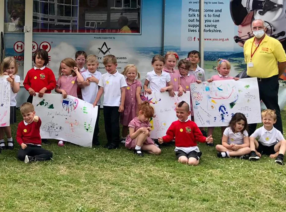 Kids sat outside school with banners