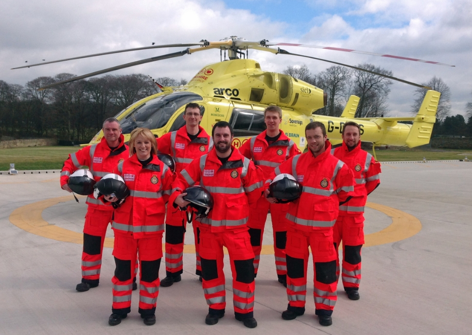 Pilots stood in front of helicopter