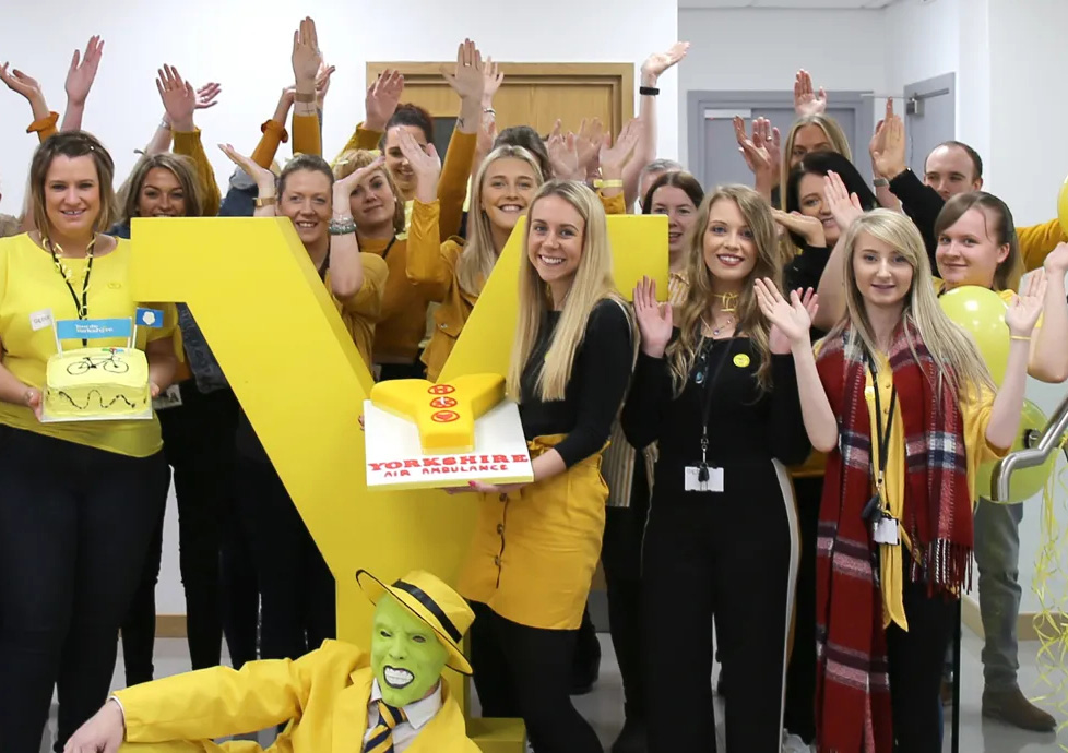 Staff holding cakes