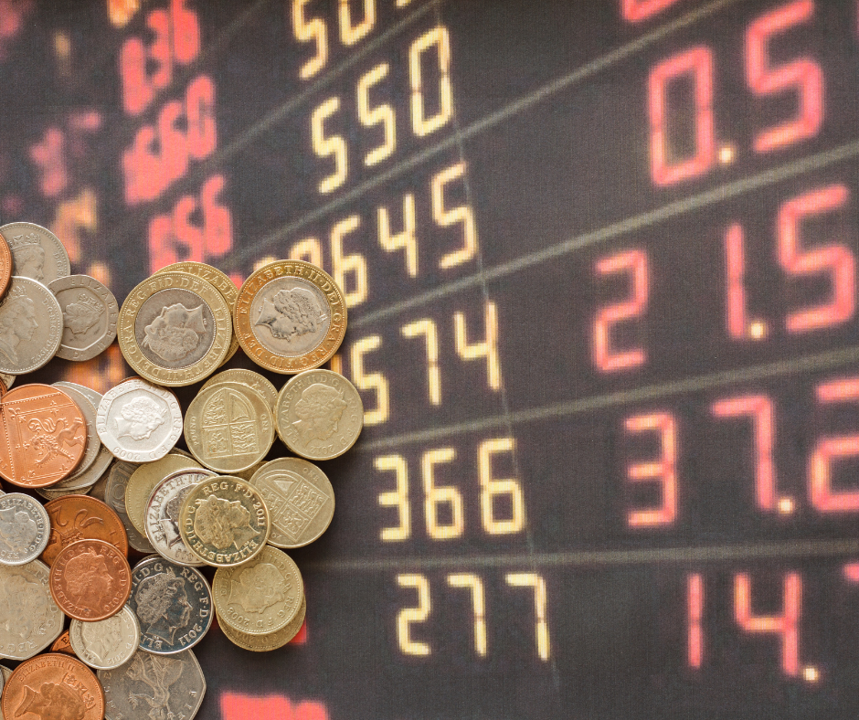 A selection of UK coins are laid on top of a board containing digital LED numbers